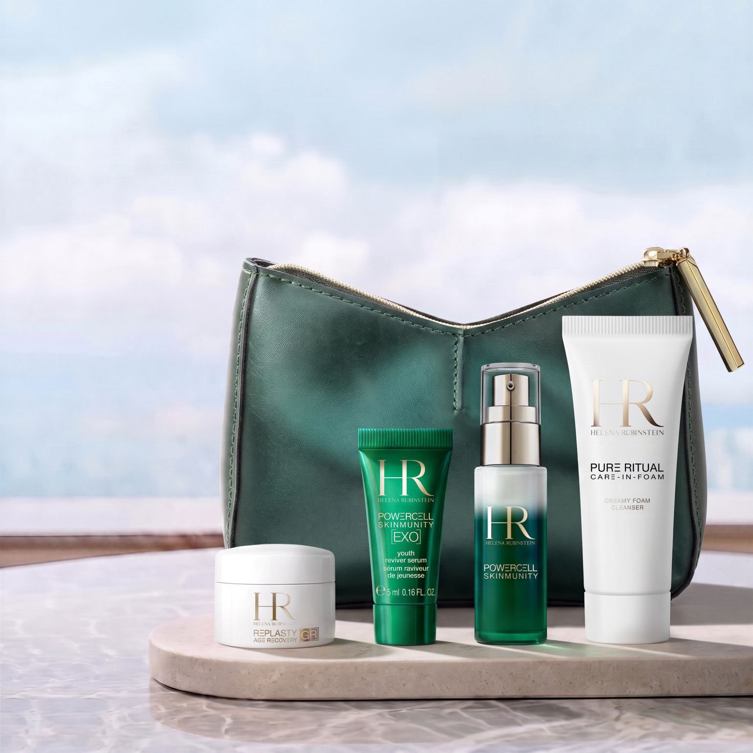 A green Helena Rubinstein cosmetic pouch displayed in front of a bright landscape, surrounded by four miniature skincare products: a Re-Plasty cream, a Powercell [EXO] mini serum, a Powercell Skinmunity serum, and a Pure Ritual cleanser.​