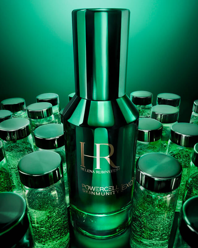 Green bottles against a dark green background, illuminated in the centre.
