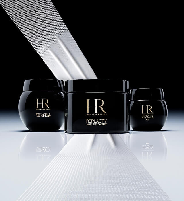 Three black Helena Rubinstein Re-Plasty Age Recovery cream jars, a large one in the center and two smaller ones on the sides, with white bands evoking bandages, against a dark background.