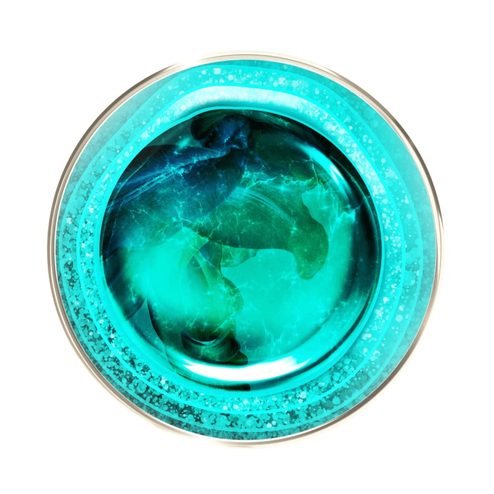 Top view of a round, transparent jar containing a liquid substance in shades of blue-green and turquoise, with bubbles, on a white background.