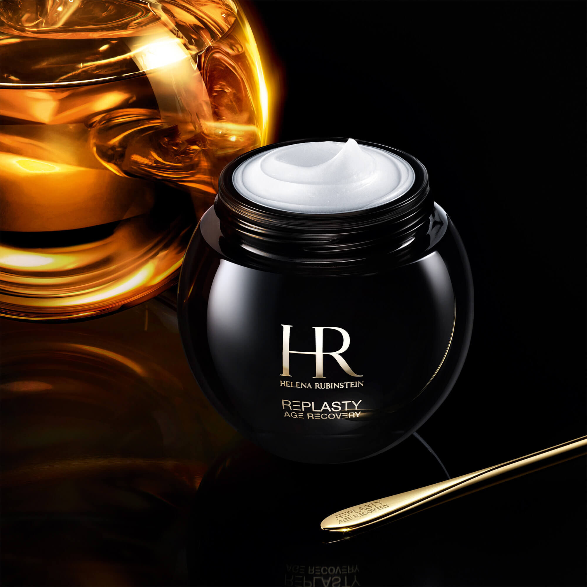 Open jar of Helena Rubinstein Replasty Age Recovery Night 30PX cream with a golden molecule on a black background