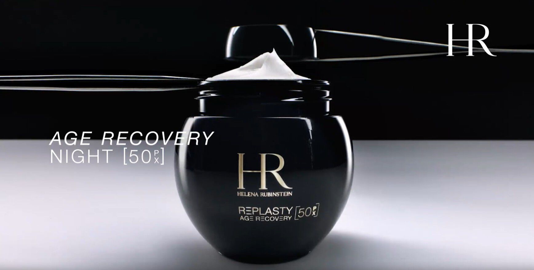 Video of the new refillable Helena Rubinstein Re-Plasty Age Recovery [50PX] jar, open with cream visible inside, displayed against a dark background.​