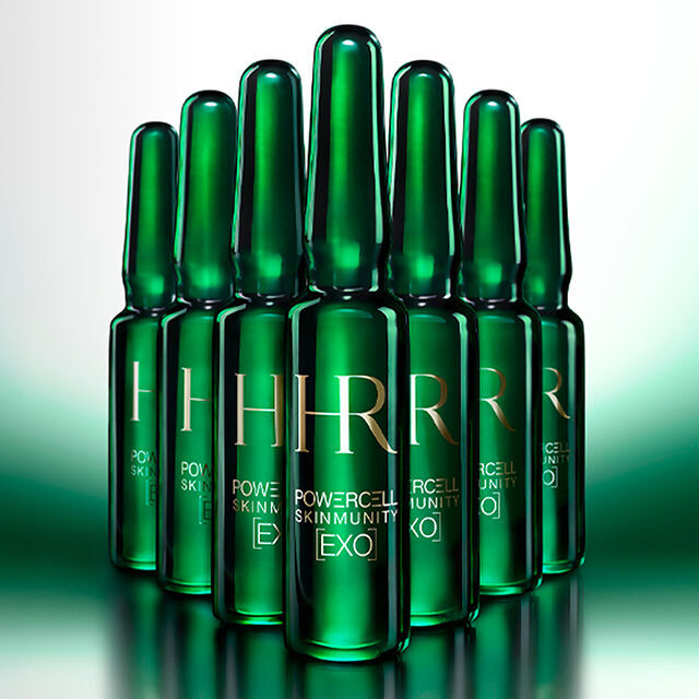 7 green ampoules in the foreground against an illuminated green background