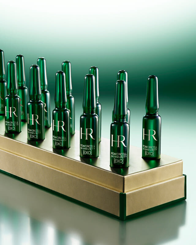 14 green Powercell Skinmunity EXO monodose ampoules on a luxury gold base.