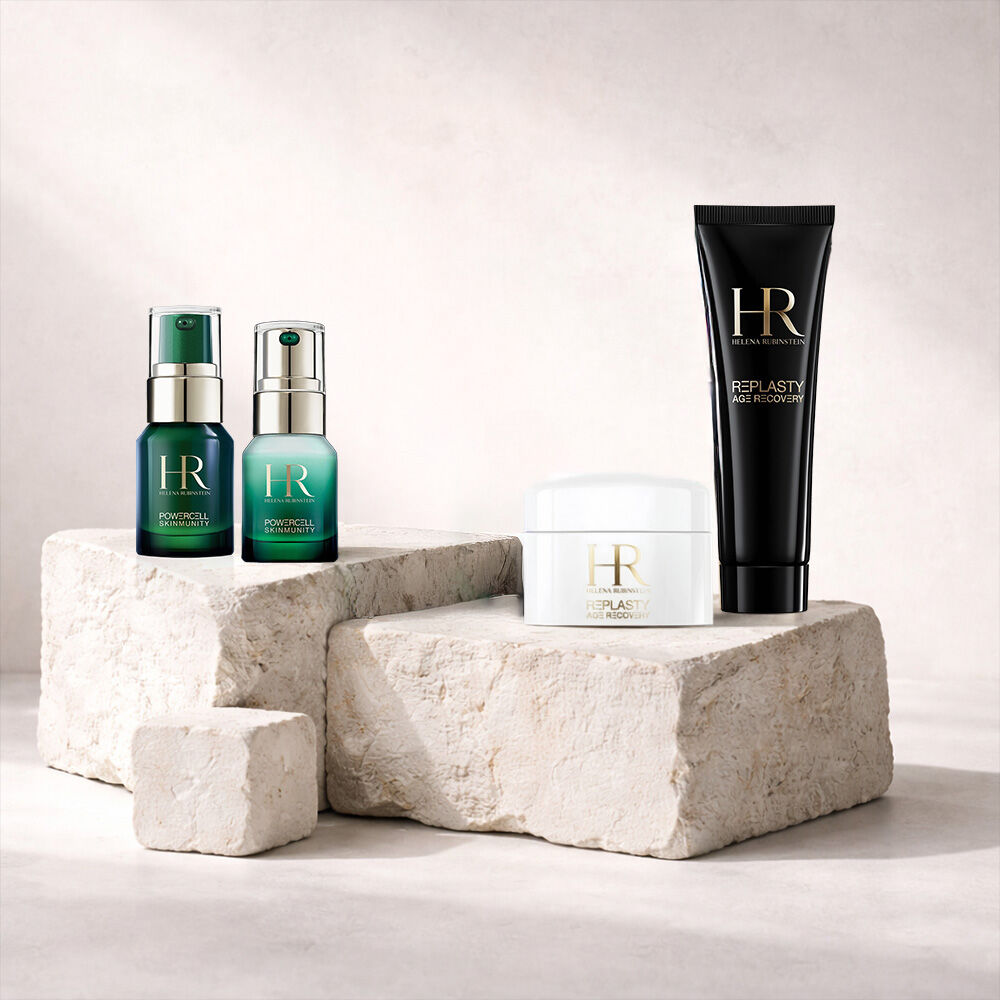 Four Helena Rubinstein skincare travel-size products on stone blocks​
