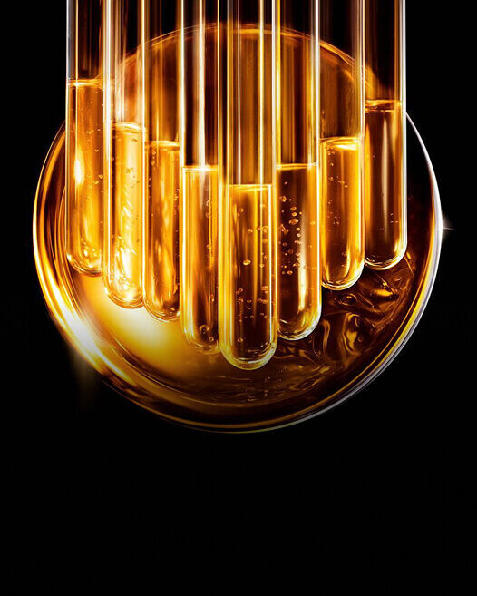 Golden liquid in test tubes, representing Pro-Xylane, a key ingredient in Helena Rubinstein REPLASTY.