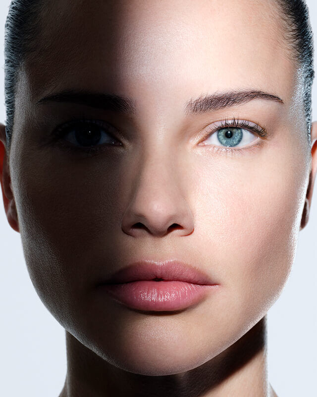Womans face with Helena Rubinstein REPLASTY cream and innovative bandage texture on her cheek.