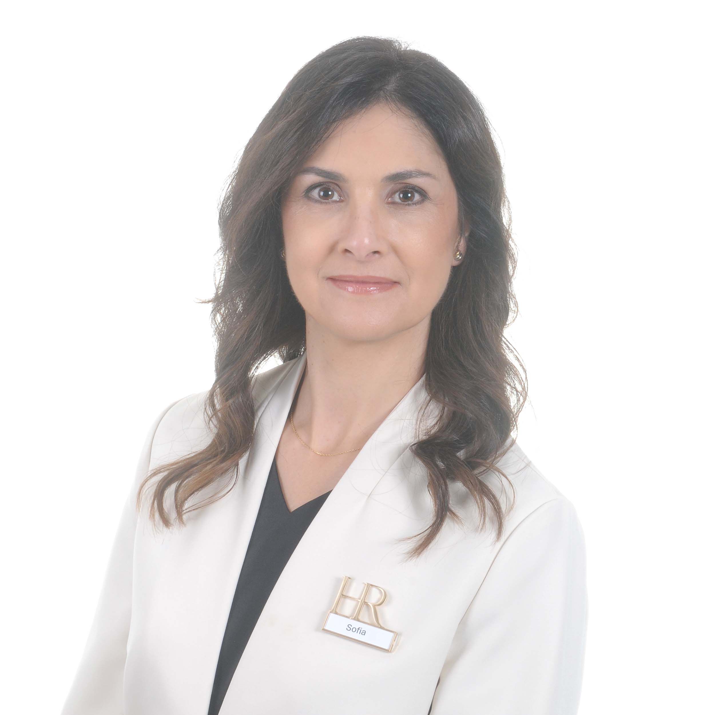 Picture of a woman with long brown hair wearing a white coat with the Helena Rubinstein badge 