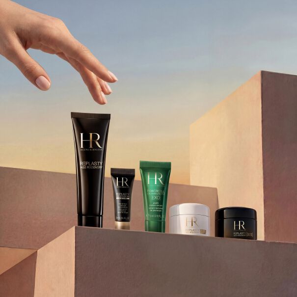 Helena Rubinstein travel skincare set on steps with pouch.​