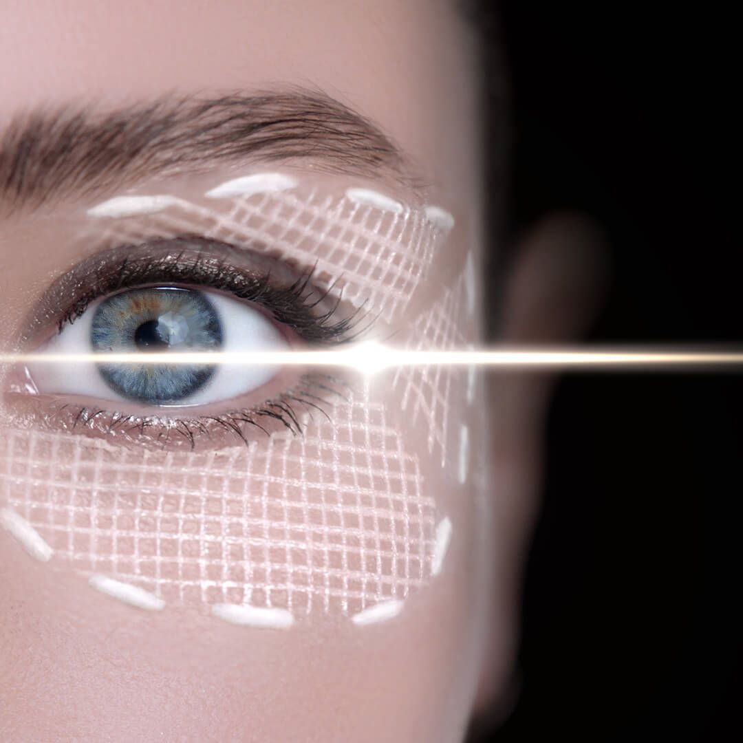 Close-up of an eye, with a grid pattern and a light beam crossing.