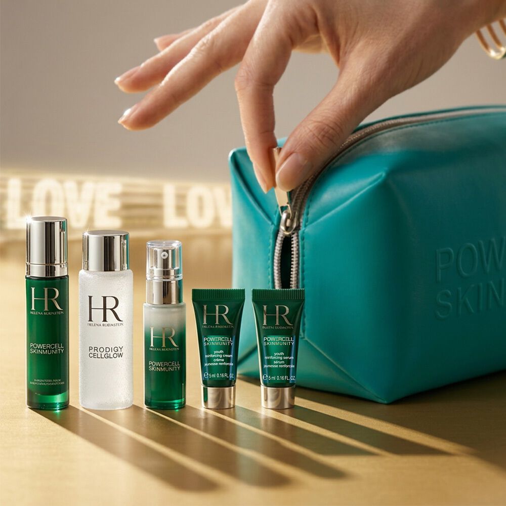 Helena Rubinstein skincare set with white pouch under wisteria.​