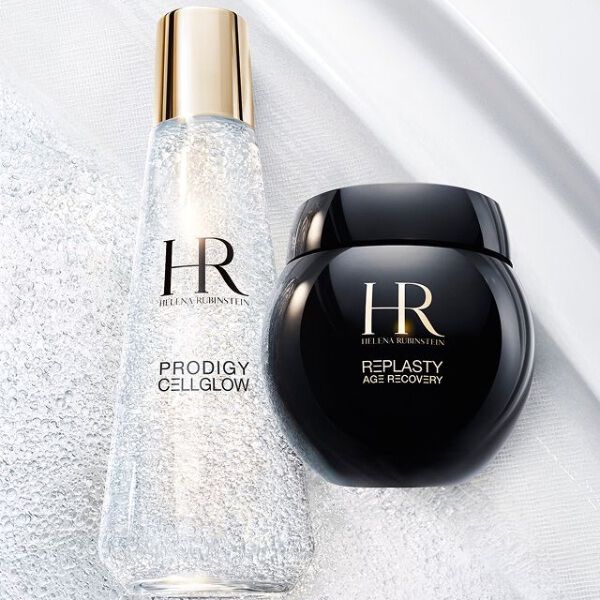 Helena Rubinstein's Prodigy Cellglow serum bottle (clear, bubbles) and Re-Plasty cream jar (black). Placed on a textured and luminous white background, symbolizing elegance and skincare effectiveness.